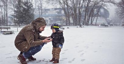 father-and-toddler-outside-in-snow