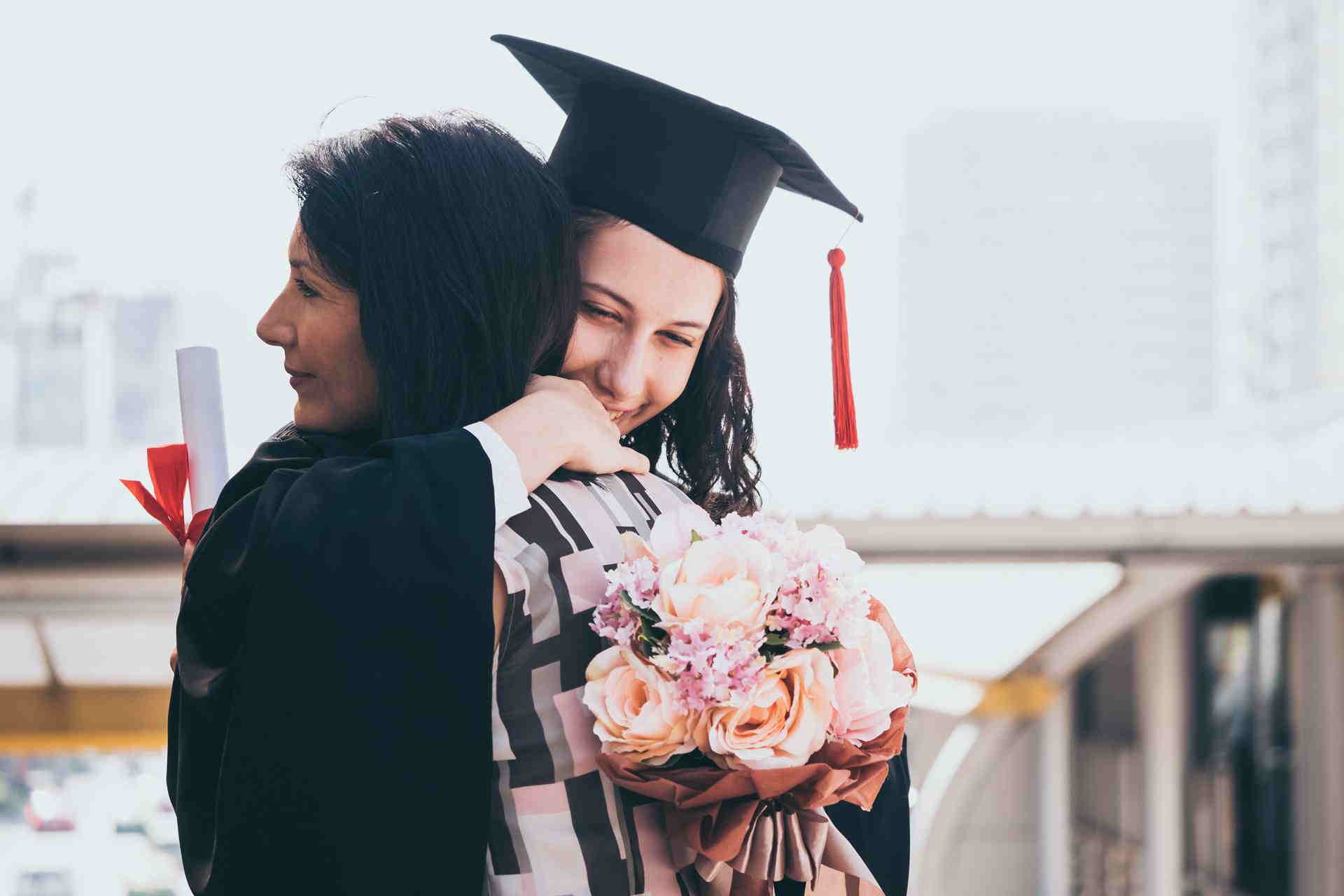 mother-daughter-embracing-on-graduation-day