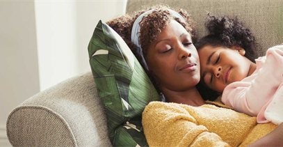 mother-and-daughter-laying-on-couch-together
